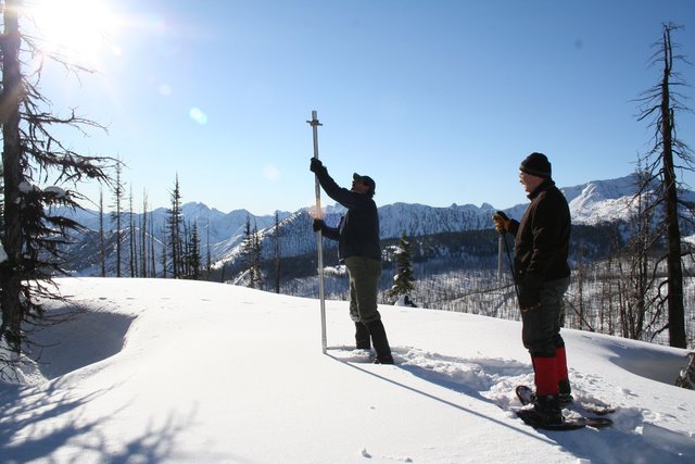Researchers measuring snow at Harts Pass