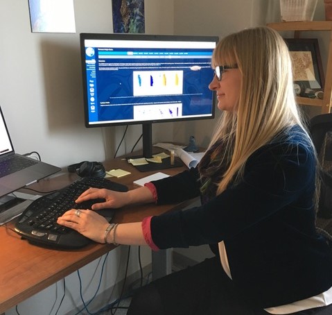 Sam working at her desk