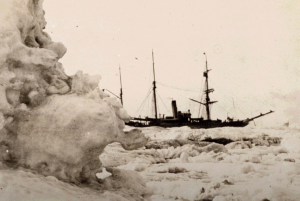 Historic photo of ship surrounded by sea ice.