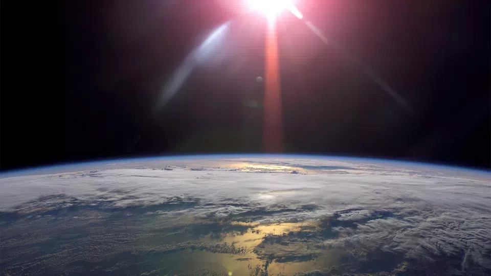 Sun over Earth from space