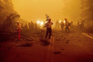 A group of firefighters at night.