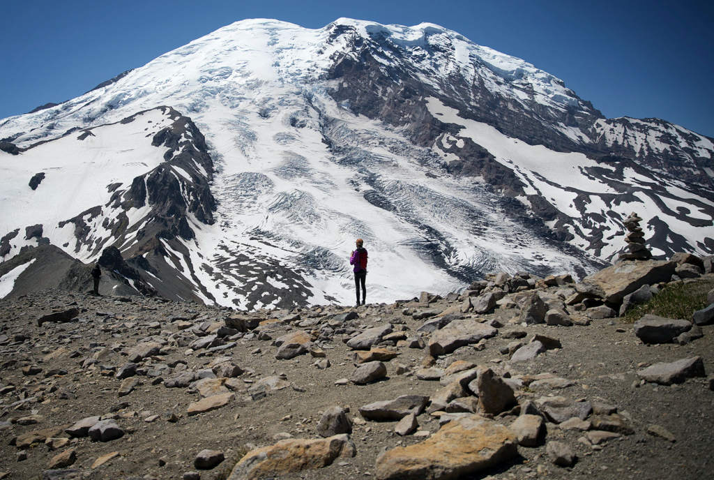 A hiker looking at Mount Rainier