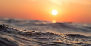 An artistic photo of ocean water during a sunset.