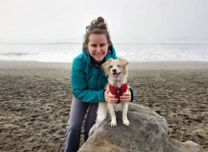 Hannah on the beach with her dog Luna