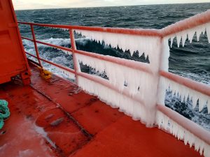 Frozen handrails aboard the deck of a ship.