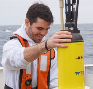 Jon holding a yellow tube used for research