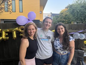 Leila and her mentors with purple balloons in the background.