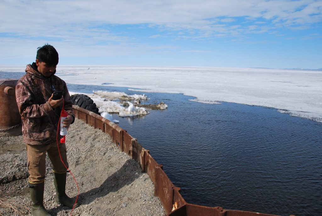 Tyler Kramer taking a salinity measurement.