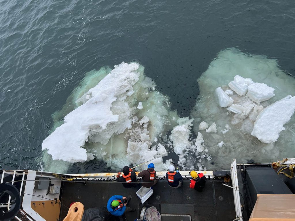 Bird's eye view of crew members collecting sea ice.