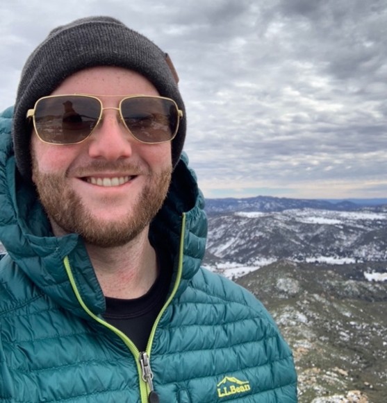 Headshot of Matt Luongo, with mountains in the background.