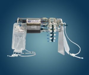 A close-up of the McLane Robotic Cartridge Sampling Instrument, a tool with a bag and multiple vials on a rotating arm.