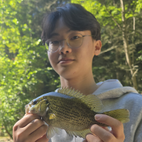 Jaehyoung Park holding up a small fish.